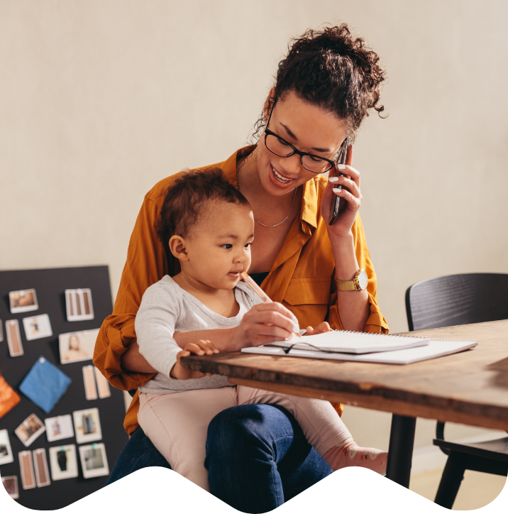 Parent holding child while on the phone